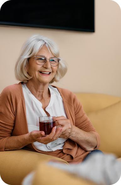 senior lady having a cup of tea and smiling while she is getting non medical home care in Philadelphia