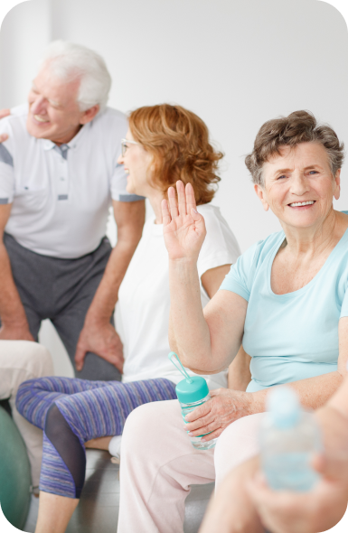 2 elderly women and one senior man smiling and talking