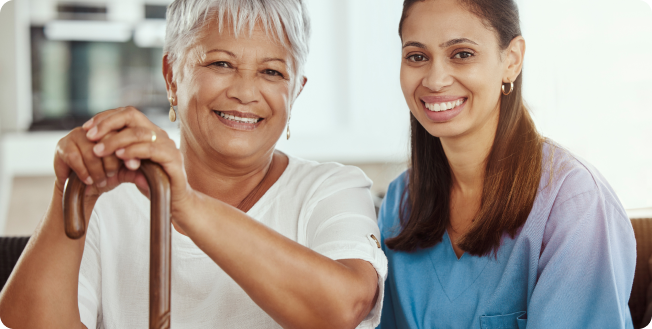 caregiver and senior lady happily smiling together