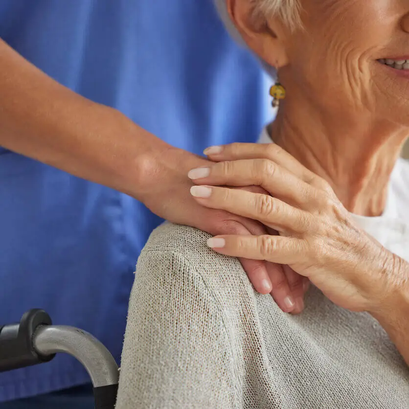 Healthcare professional showing kindness to an elderly patient. home and community-based program