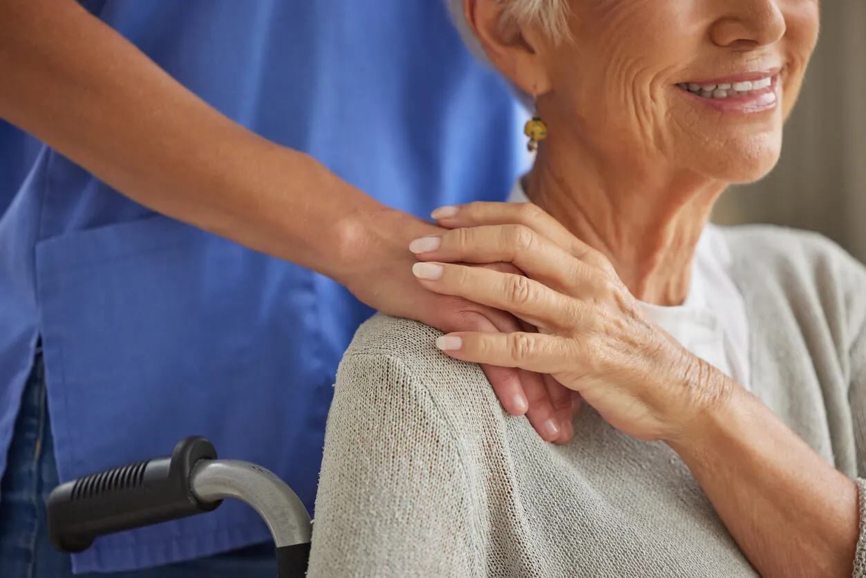 Healthcare professional showing kindness to an elderly patient.