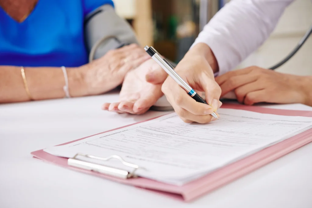 Caregiver helping an elderly person review and sign a detailed home care contract.