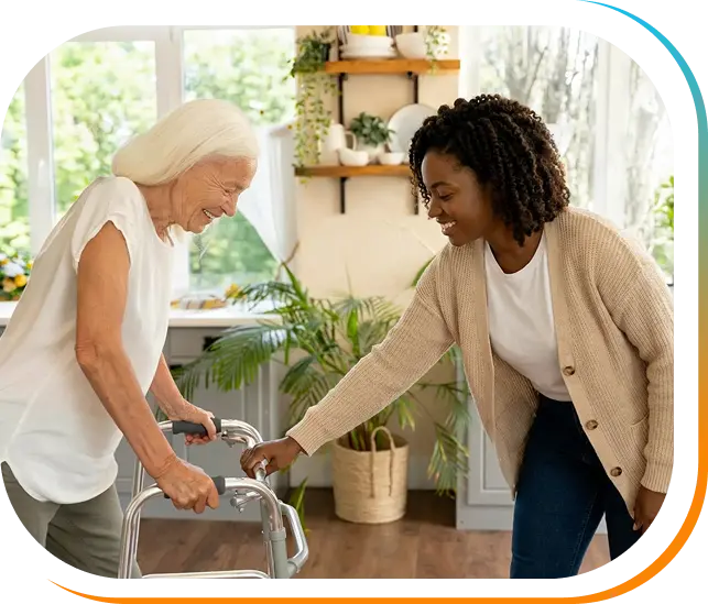 Caregiver assisting an elderly woman using a walker at home.